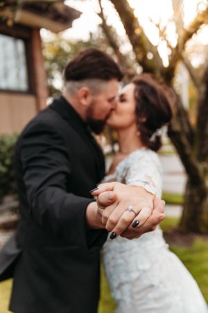 Romantic bride and groom kissing at a scenic wedding venue by Branson, MO Photographer L. Ballenger Photography.