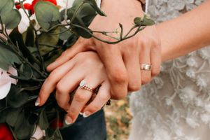 Close-up of a couple’s hands and rings during a woodland engagement photo session in Branson, MO by L. Ballenger Photography.