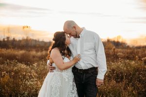 Intimate outdoor wedding portrait of a bride and groom at golden hour by Branson, MO Photographer L. Ballenger Photography.