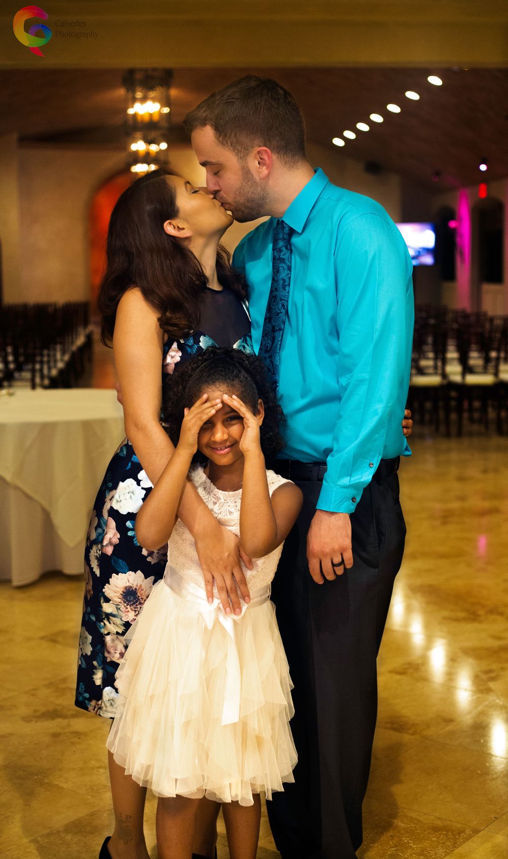 Future Bride and Groom Engagement Photo Kissing With Child