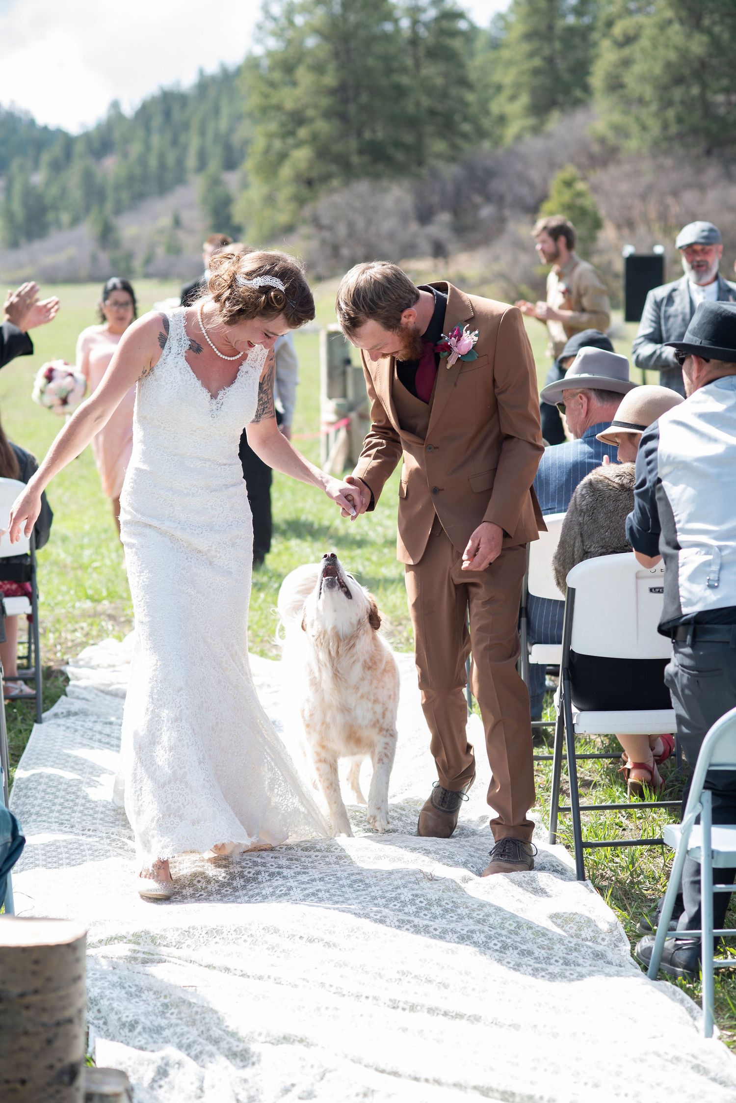 Bride and Groom walking down the aisle with their dog