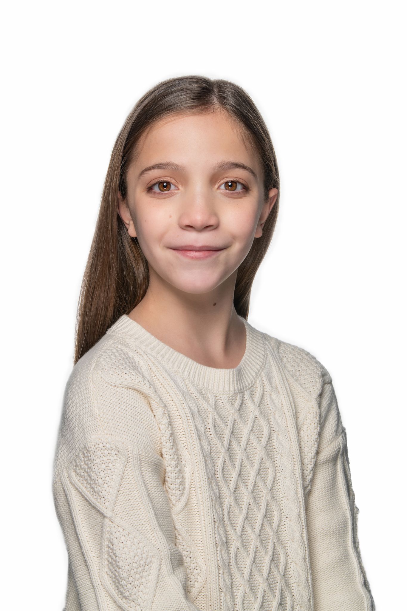Studio portrait featuring gentle smile and cream cable knit sweater against white background.