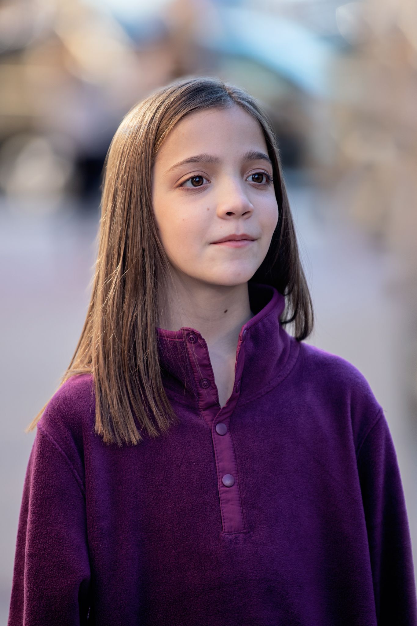 Outdoor portrait in purple fleece pullover with soft natural lighting.