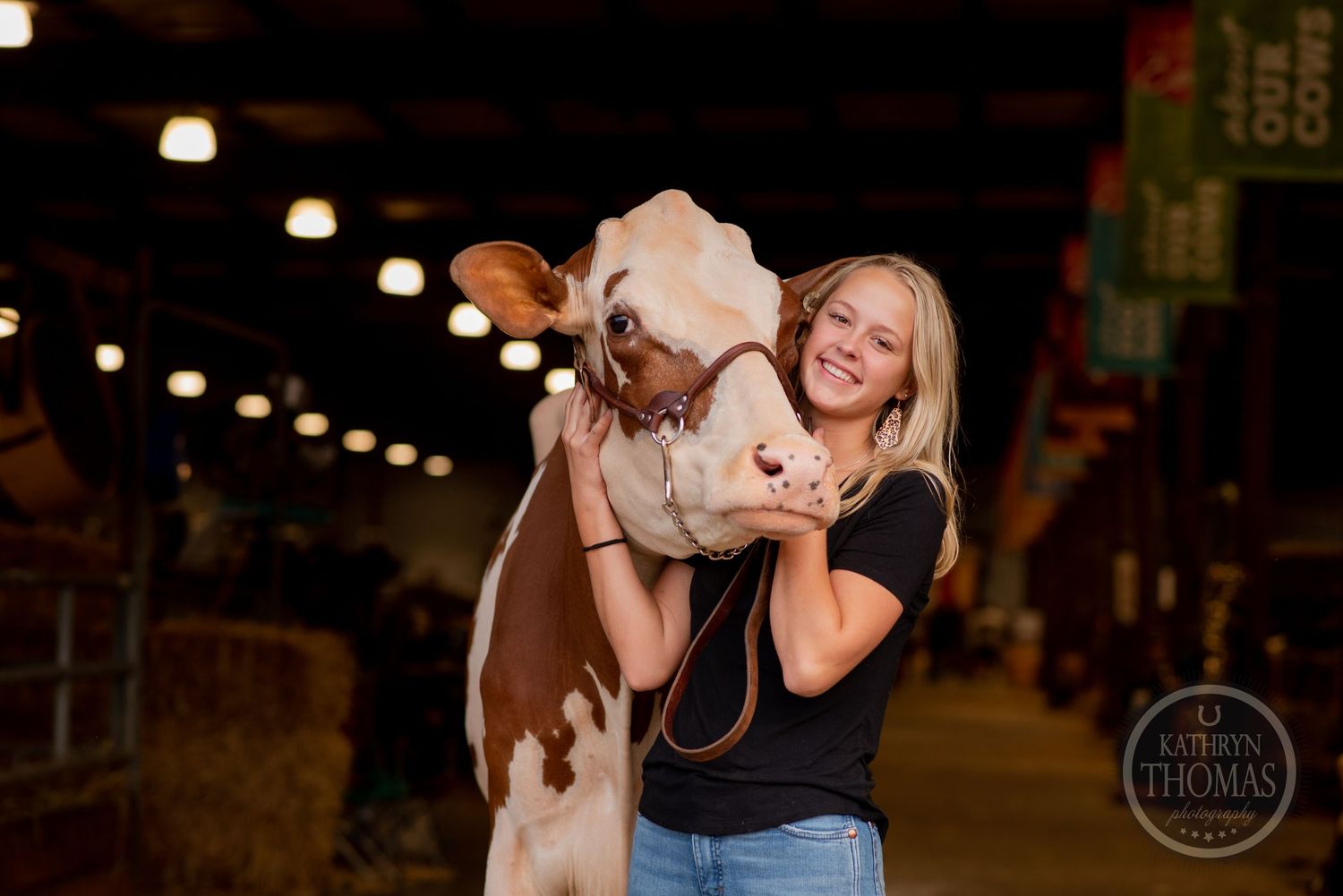 A dairy cow and handler share an affectionate moment during an indoor photo session.