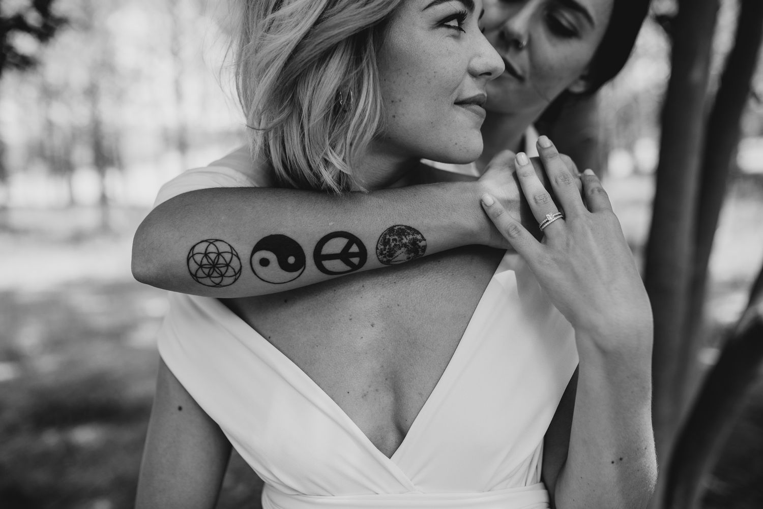 A gay couple with tattoos posing on their wedding day in Copenhagen