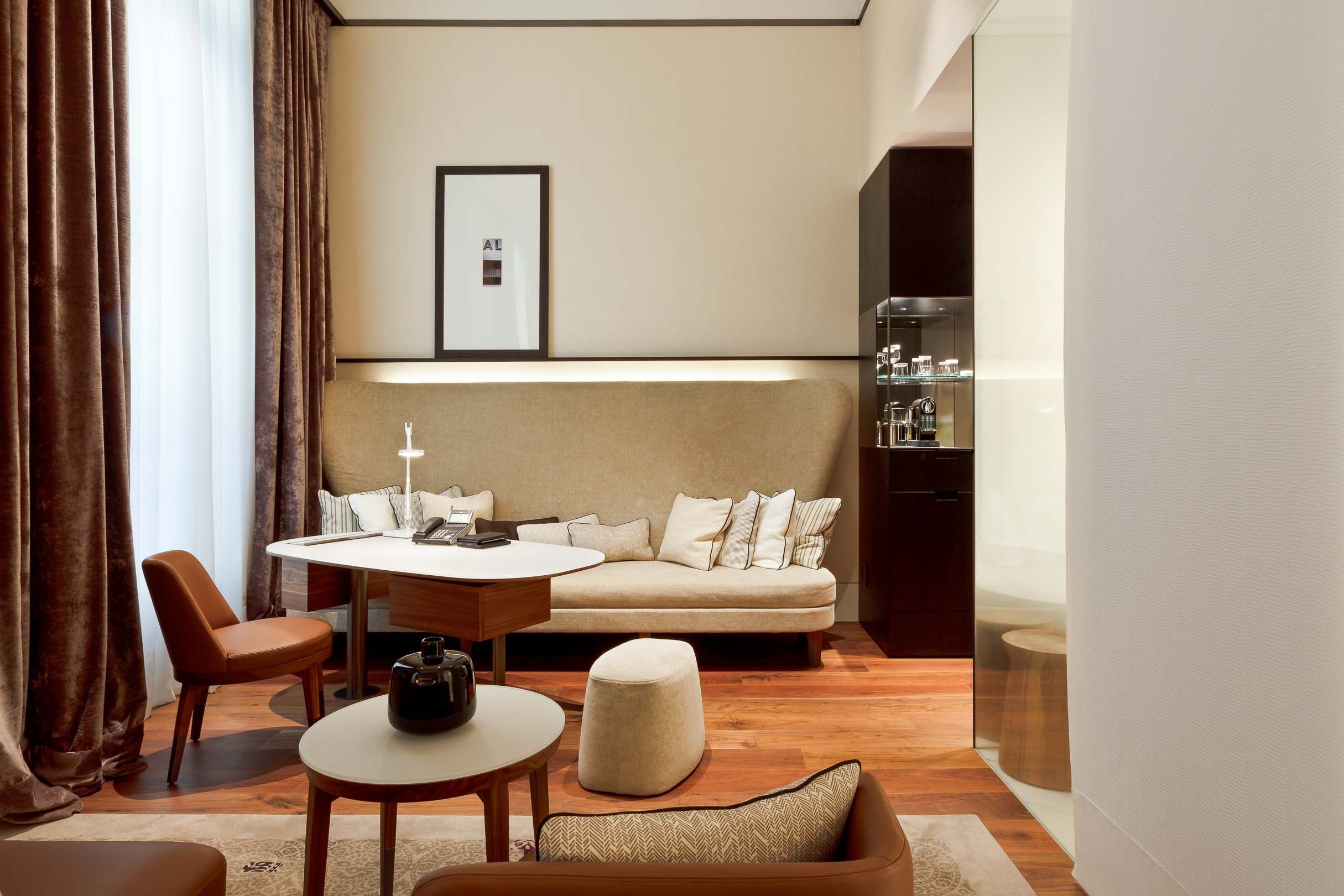 Modern living room with beige sofa, brown curtains, and minimalist furniture arrangement.