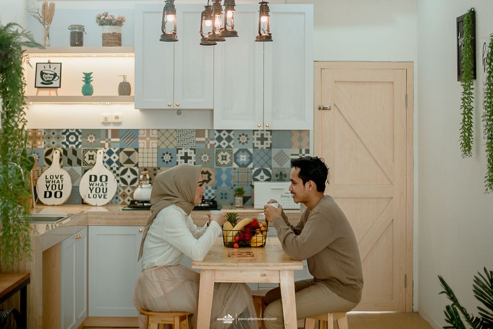 Modern kitchen scene with geometric tile backsplash and hanging pendant lights.