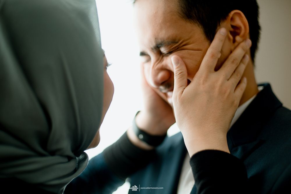 A tender moment shared between a couple with expressive emotion and laughter.