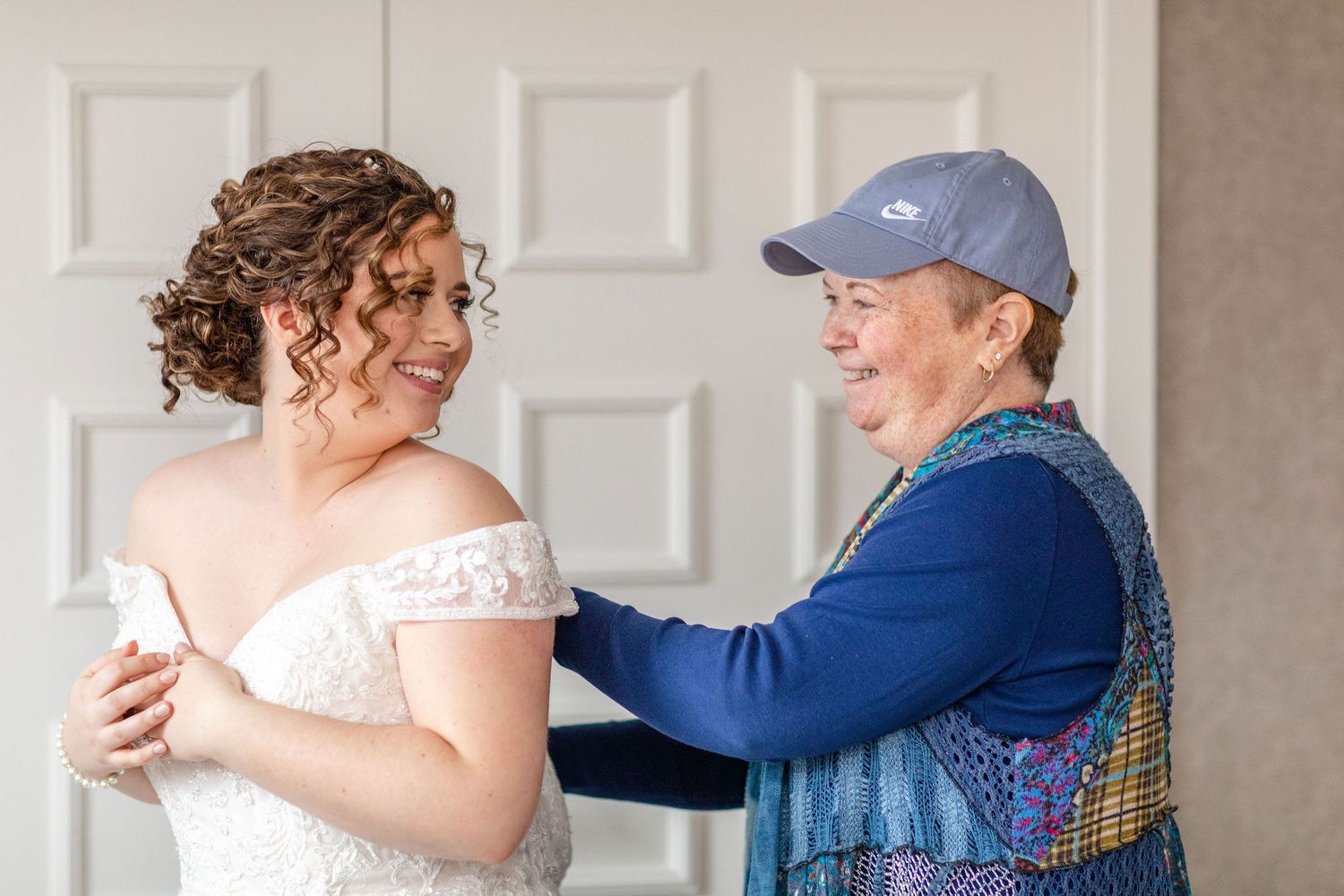 Emotional getting ready moment in a bridal suite with morning light.