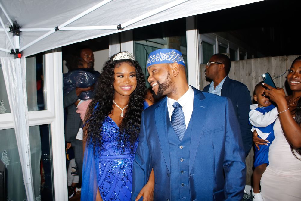 Couple in matching royal blue formal attire at an event.
