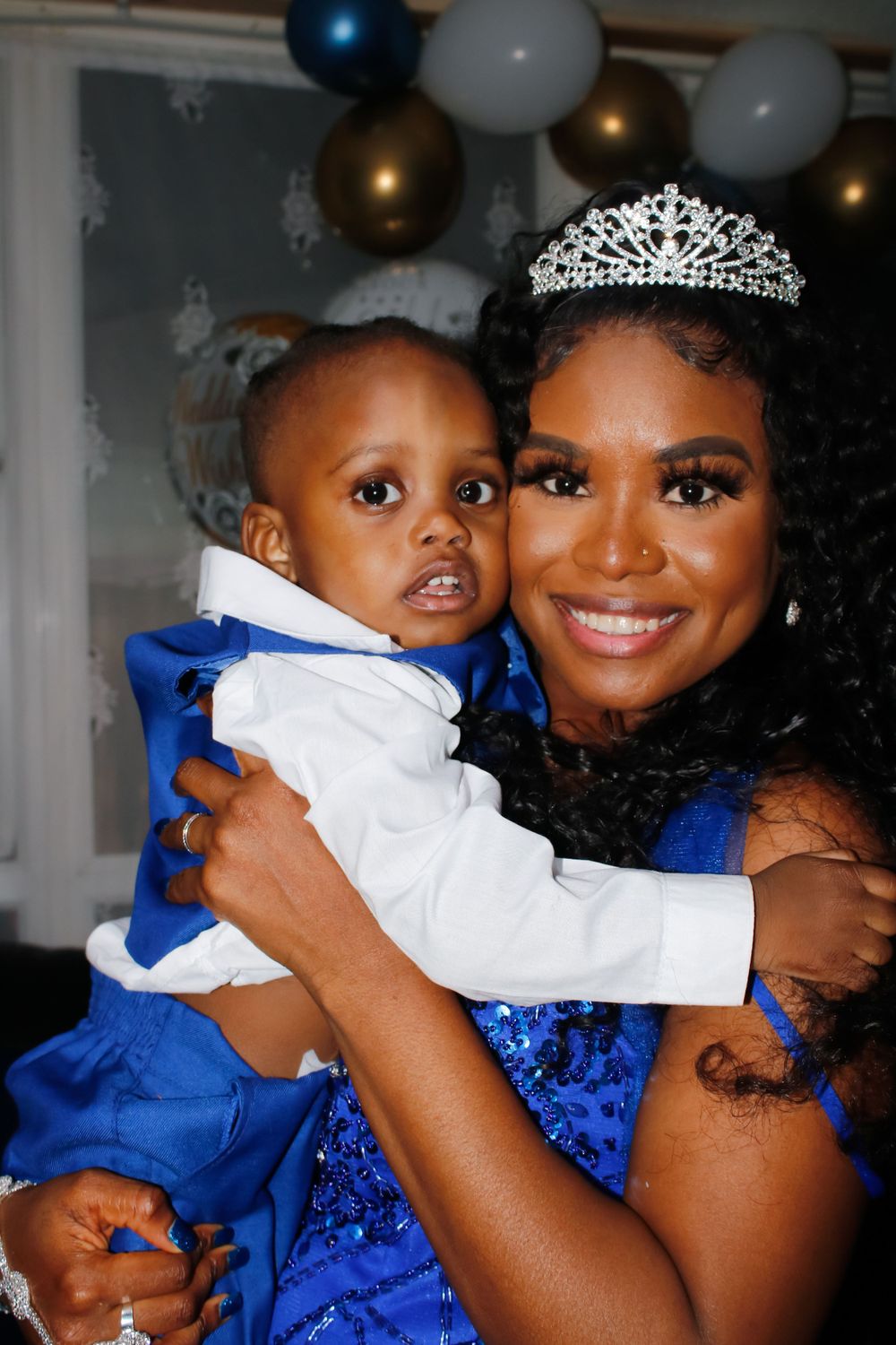 A celebratory moment captured with formal attire and a sparkling tiara.