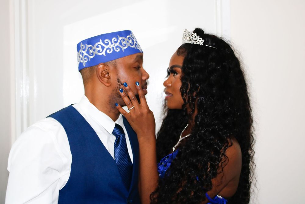 Intimate moment between couple in formal blue attire and matching accessories.
