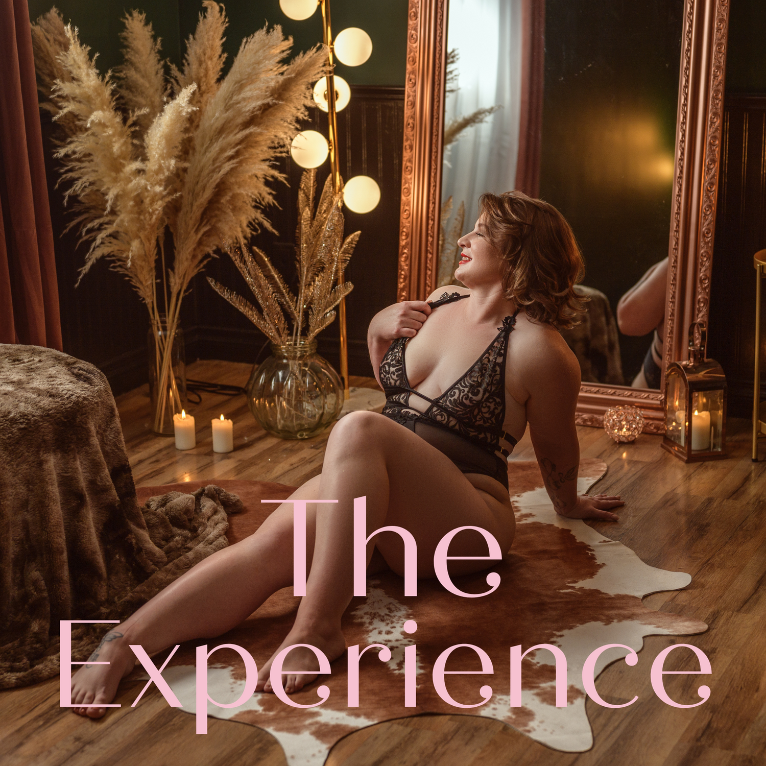 Romantic boudoir setup with pampas grass, string lights and an antique mirror creating a warm, intimate atmosphere.