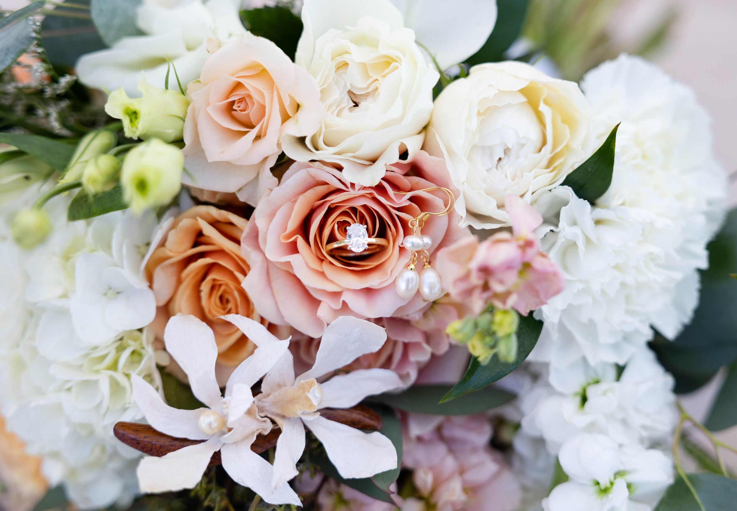 detail ring shot with bouquet at Chico, California Wedding at lakeside pavilion
