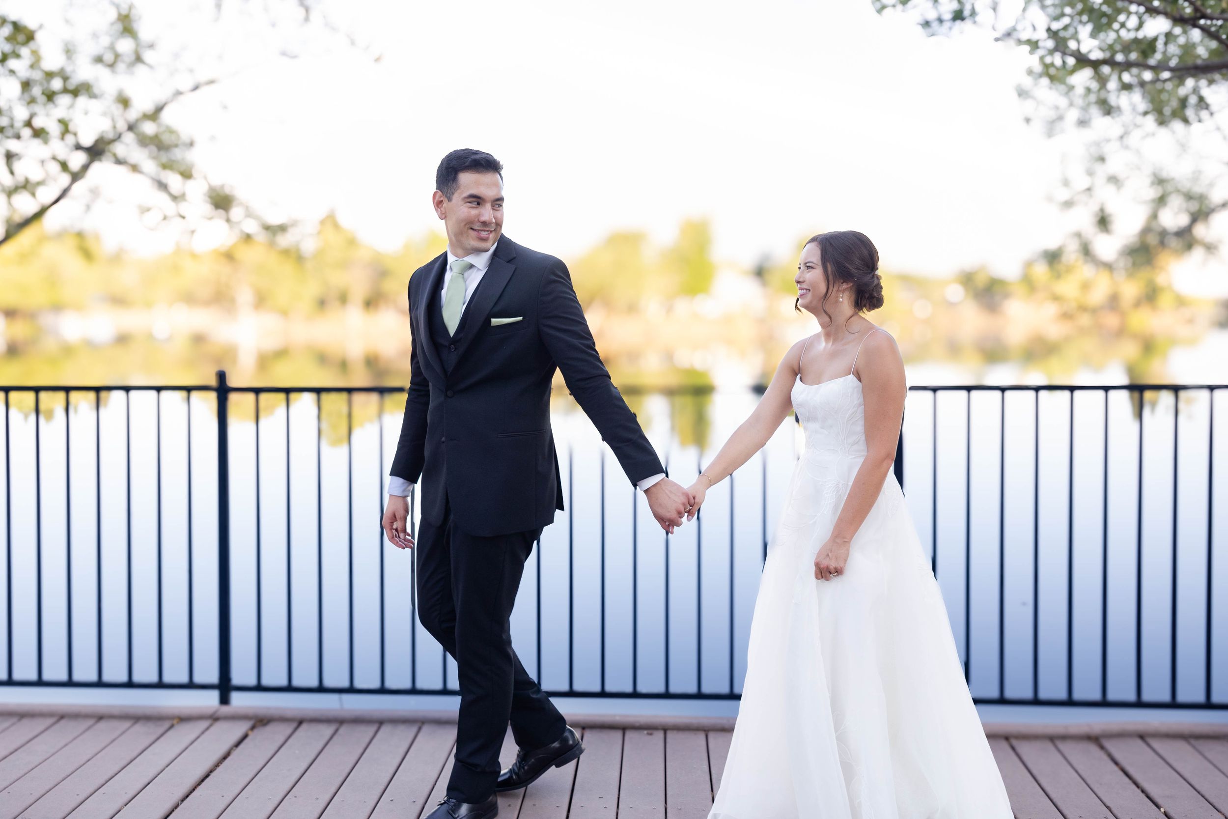 Bride and Groom Portraits Lakeside Pavilion Chico, California with lake behind them