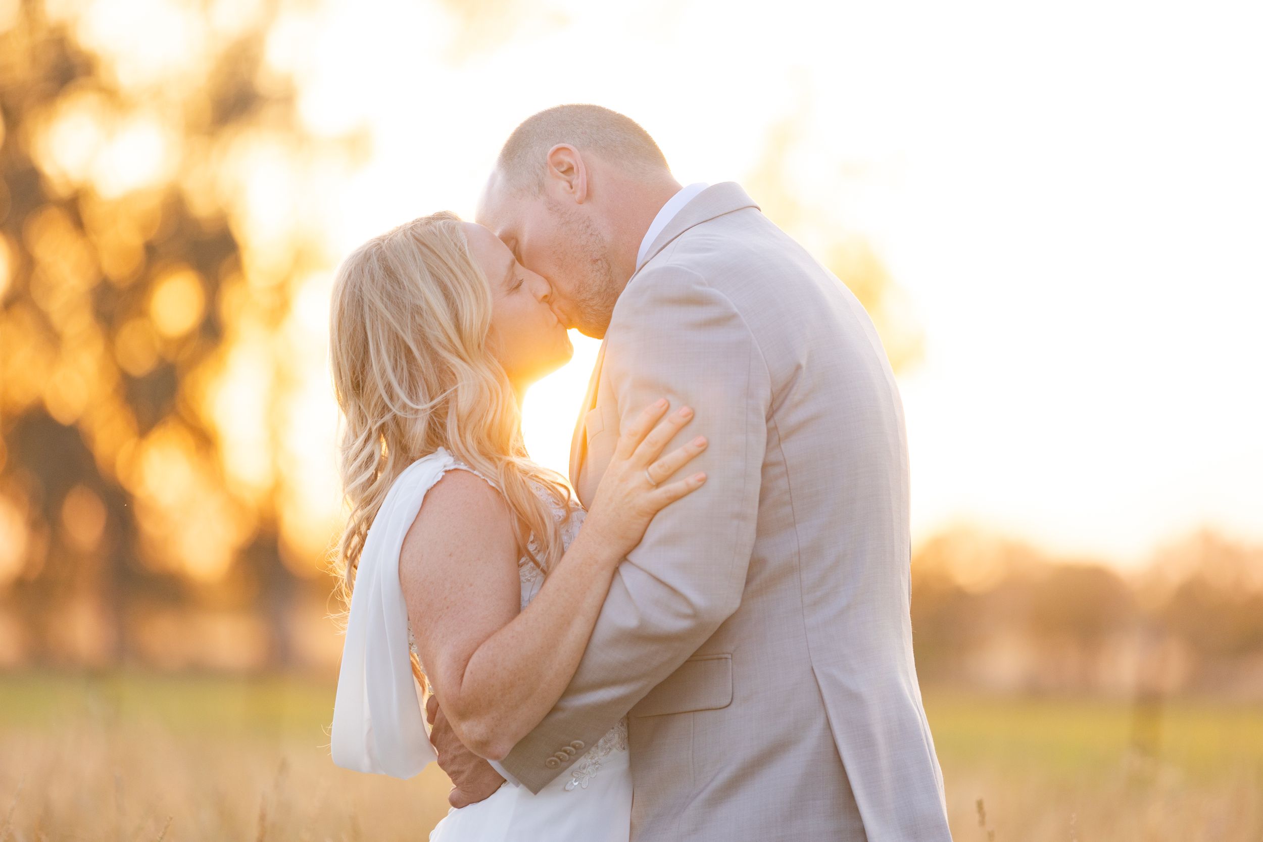 Bride and Groom in Field in Orland, California Wedding, Northern California with sun behind them