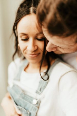 A tender moment captured in warm tones showing closeness and gentle smiles.