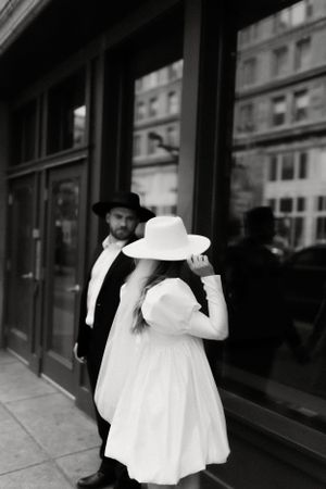 Artistic black and white street photography featuring contrasting black and white formal attire.