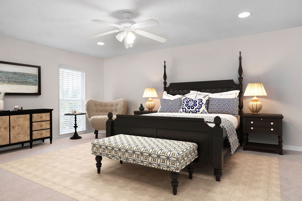 Elegant master bedroom with dark wood four-poster bed, patterned bench, ceiling fan, and neutral decor.