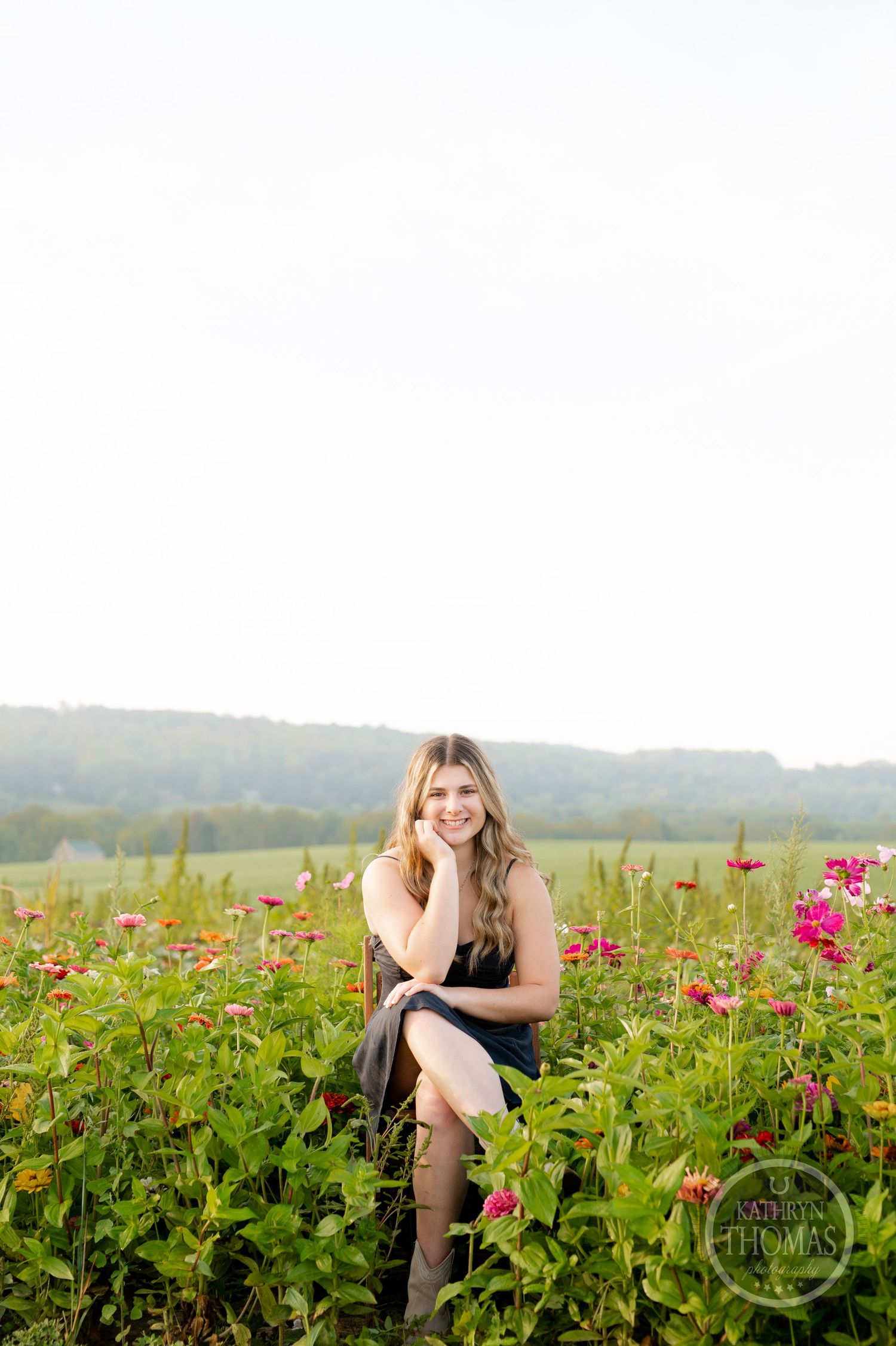 Ethereal outdoor portrait session in a meadow filled with colorful summer wildflowers.