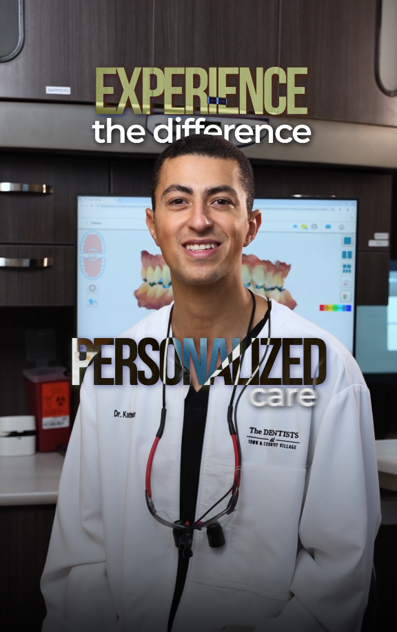 Smiling dentist Dr. Kaief in white coat stands before dental software screen with text Experience the Difference Personalized Care.