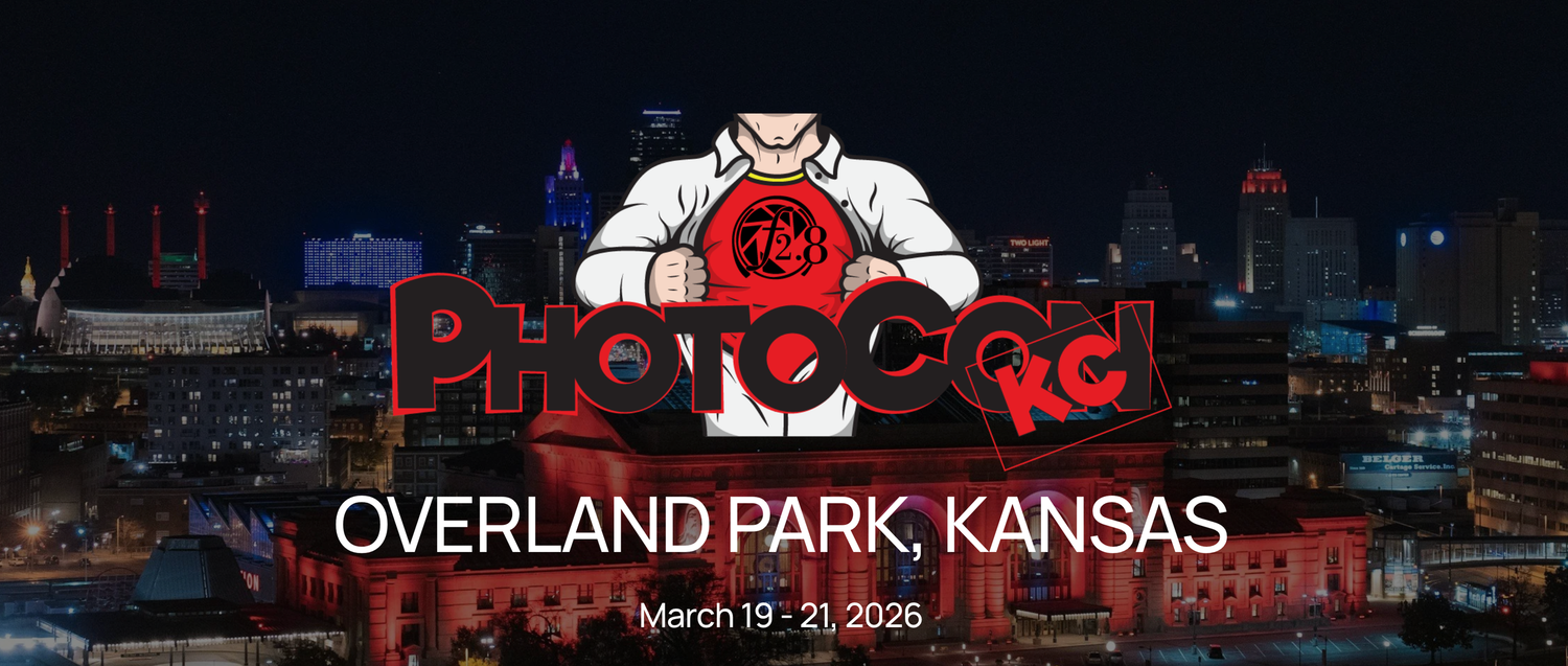 Photocon-KC logo of "superhero" guy pulling his shirt open to reveal F2.8 aperture. The logo is overlaid a cityscape photo of Kansas City