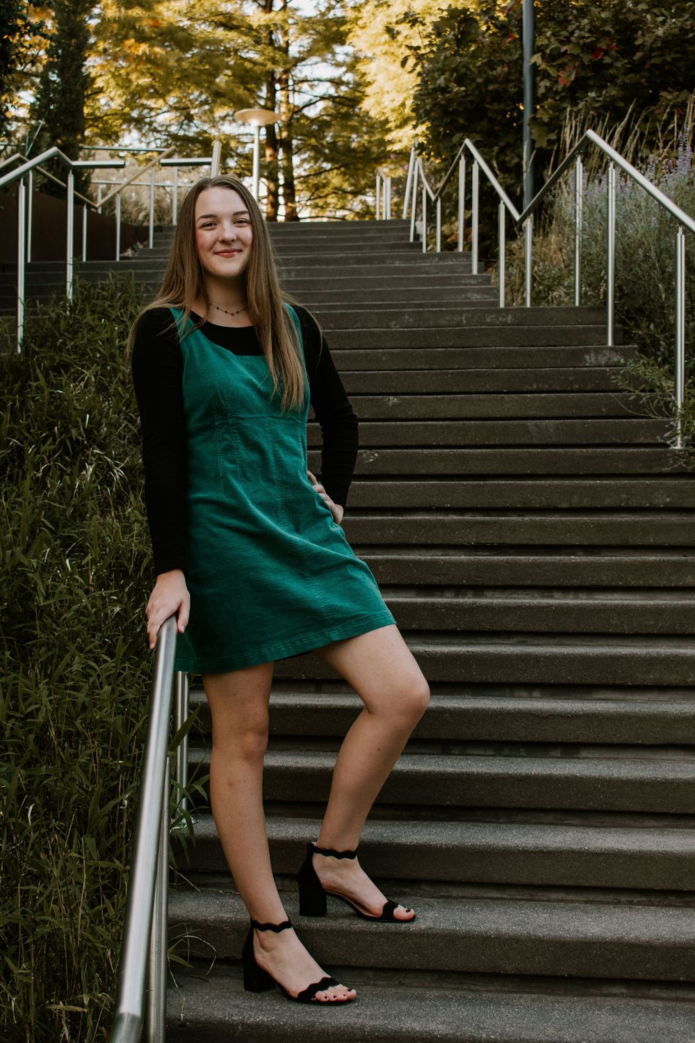 senior posing concreate staircase at Myriad Botanical Gardens in Oklahoma City, Oklahoma