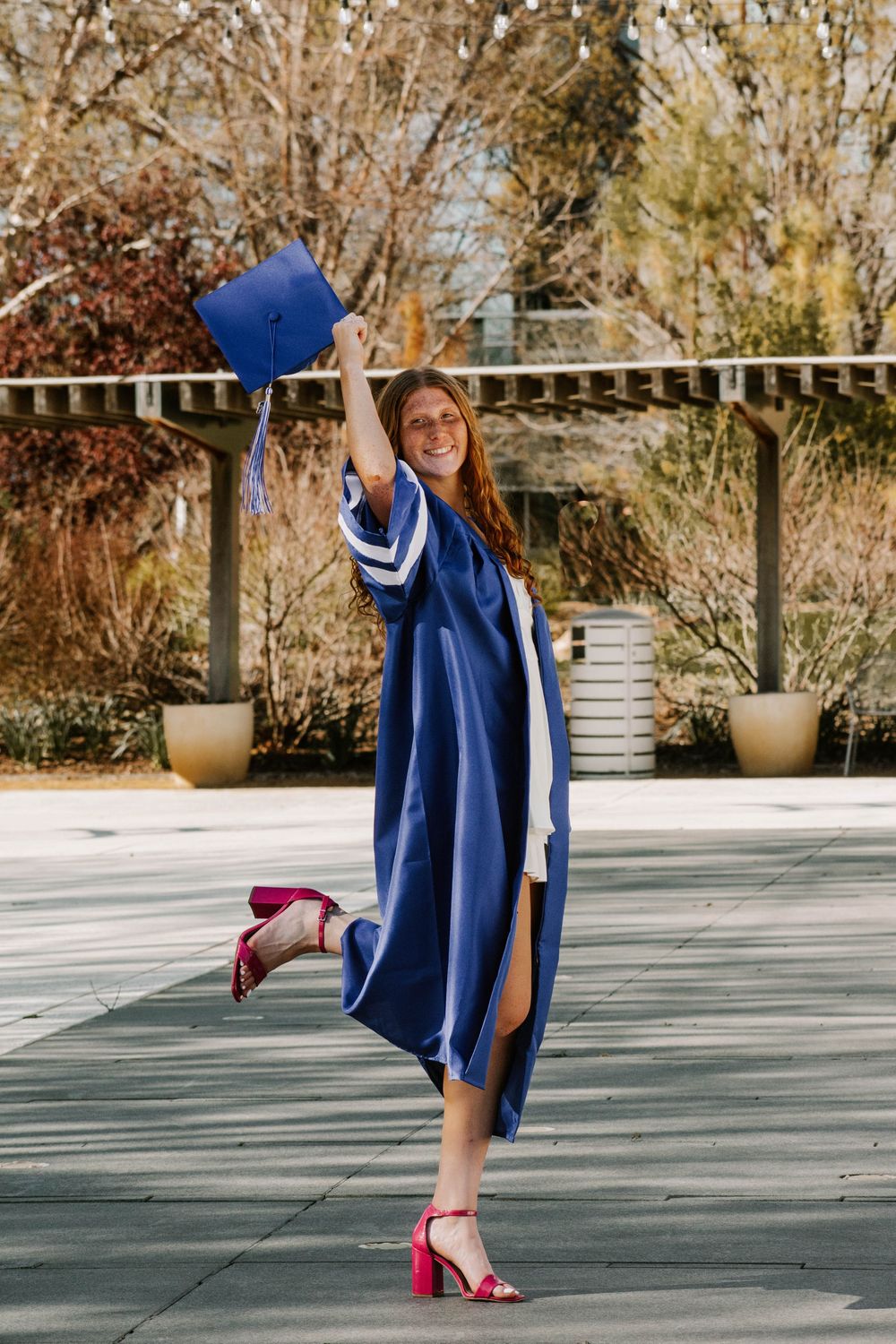 senior posing in cap and gown at Myriad Botanical Gardens in Oklahoma City, Oklahoma.