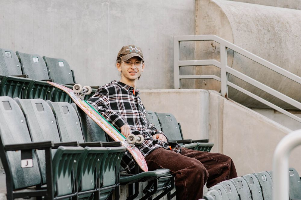 senior posing in stadium seats at Myriad Botanical Gardens in Oklahoma City, Oklahoma