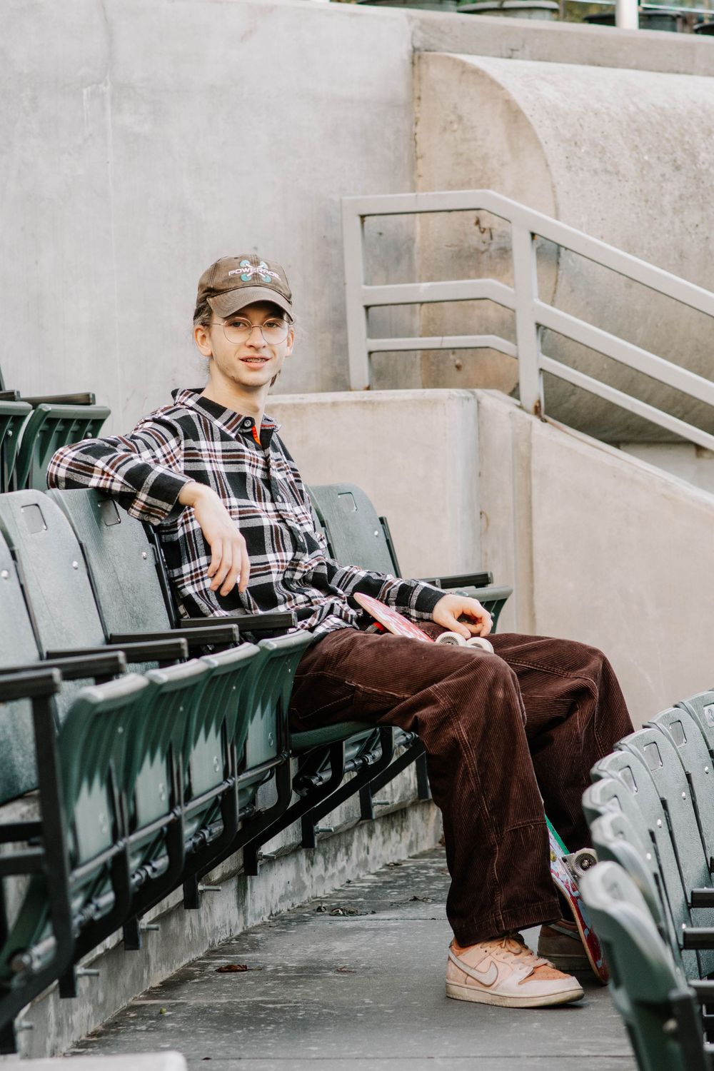 senior posing in stadium seats at Myriad Botanical Gardens in Oklahoma City, Oklahoma.