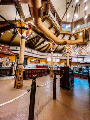 Interior view of a themed retail space with exposed ductwork and decorative columns.