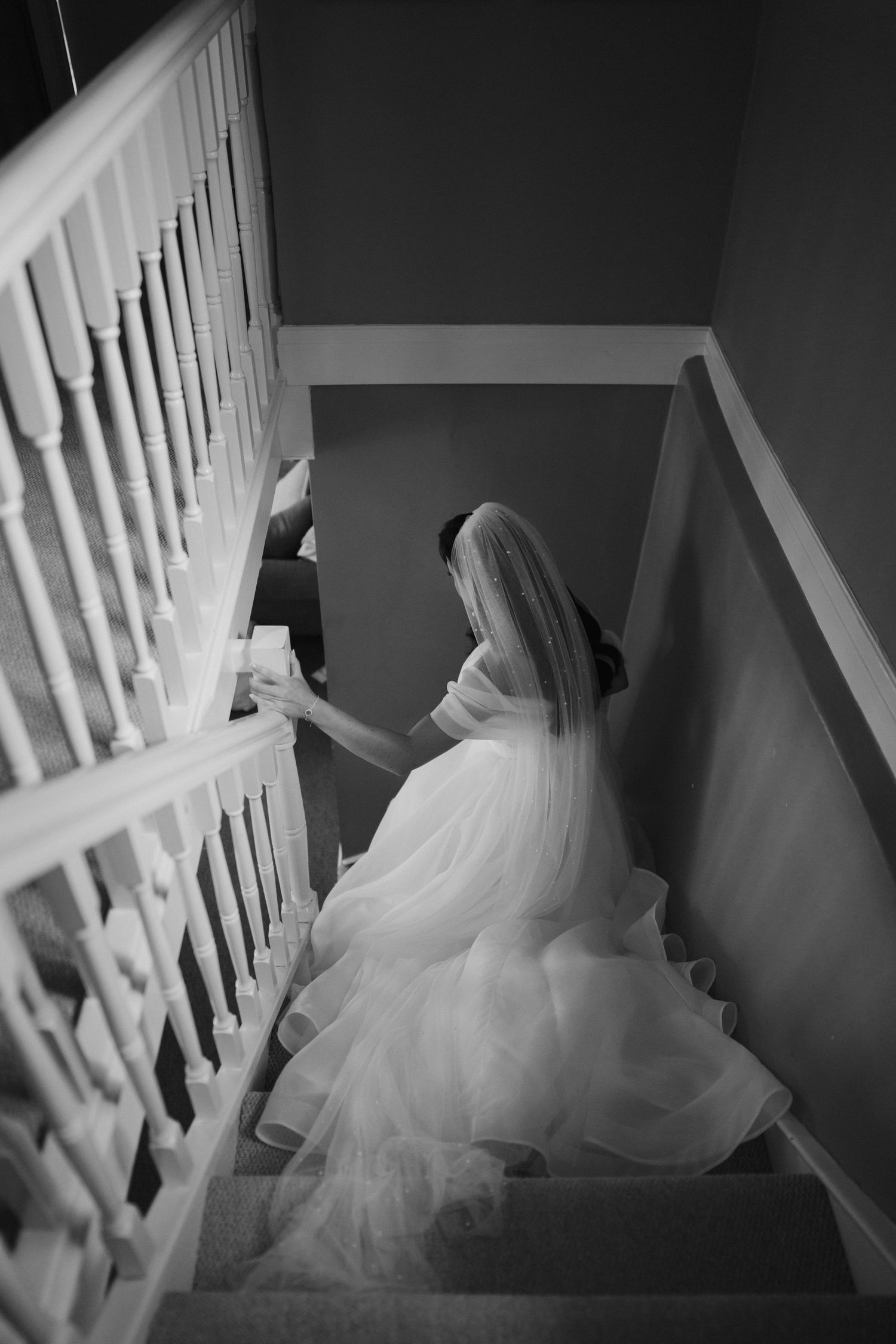 bride walking down stairs at the new inn cirencester