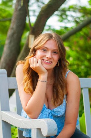 Portrait of a young woman sitting on a bench