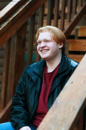 A portrait of a senior boy laughing