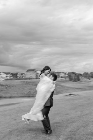 Black and white photos of couple spinning in an open field.