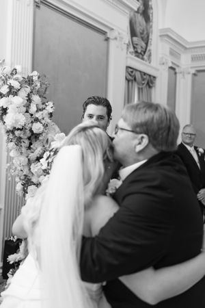 Black and white candid moments of wedding ceremony with floral arrangements.