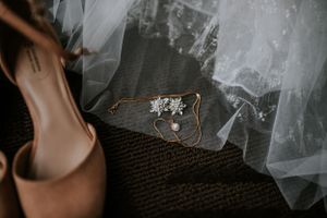 Elopement details before wedding of dress, shoes, earrings, necklace in hotel in Las Vegas, Nevada.