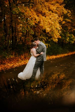 Bride and Groom kissing with Fall Foliage in Clarksville Tennessee.