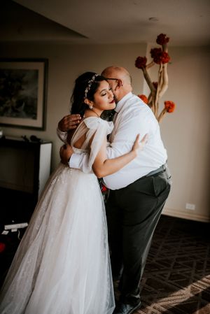 Elopement photo of bride and her father hugging during a quiet moment during her getting ready time in Las Vegas, Nevada.