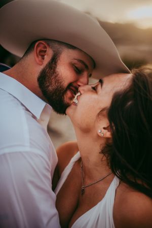 Elopement couple kissing at sunset at the river in Hill Country, Texas.