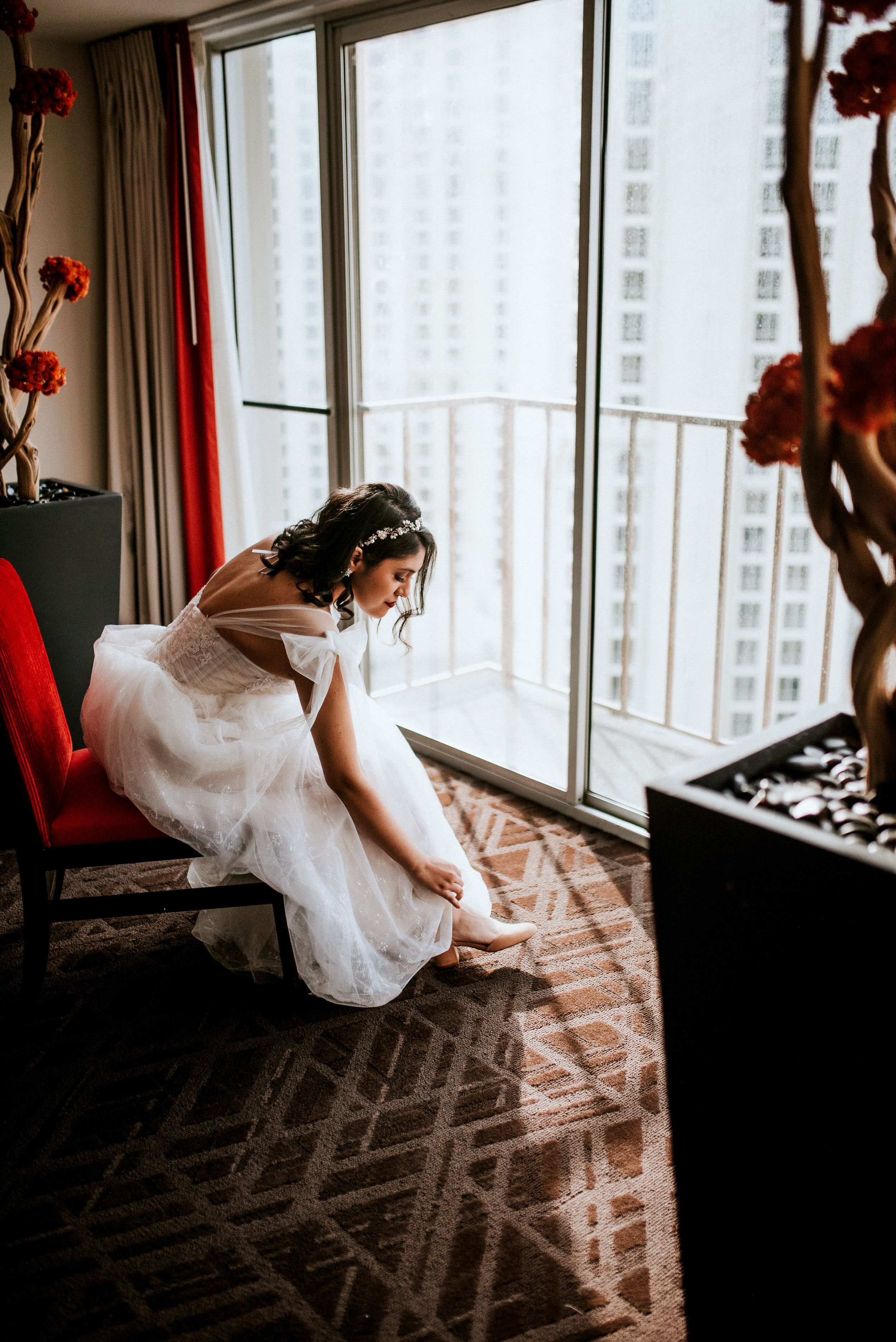 Bride putting on her shoes in the hotel in Las Vegas, Nevada.