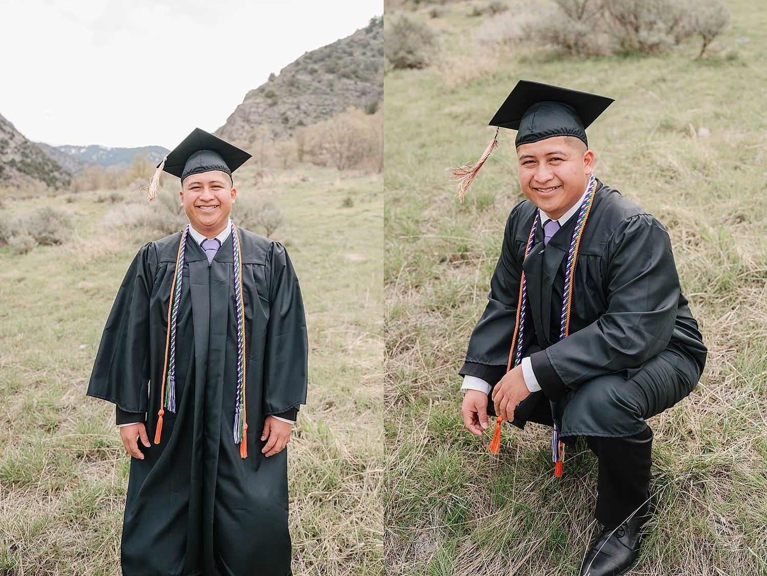 Two graduates in black caps and gowns pose on a grassy hillside during their graduation celebration.