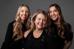Professional studio portraits showing joyful expressions and warm smiles against a dark background.