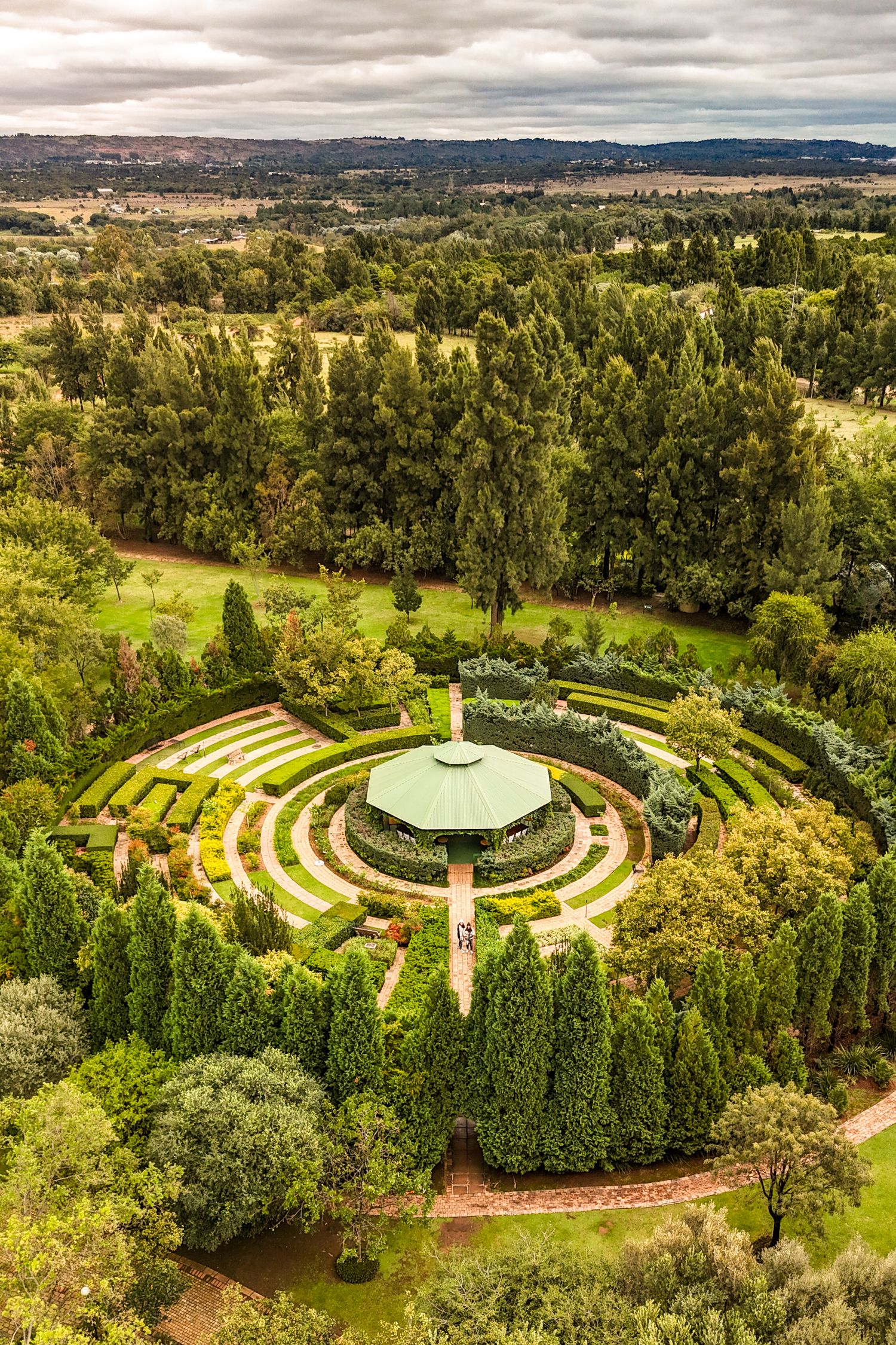 Drone view of a unique stay 's maze, surrounded by lush gardens, showcasing unique outdoor experiences and boutique accommodation.