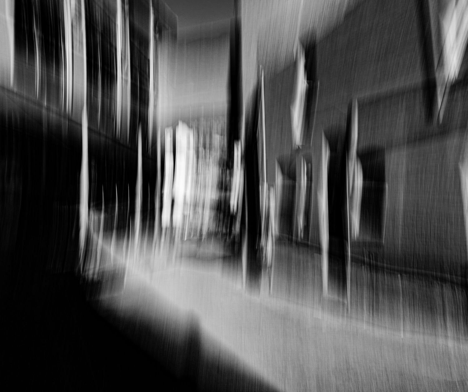 Abstract black and white architectural study with dramatic vertical motion blur.