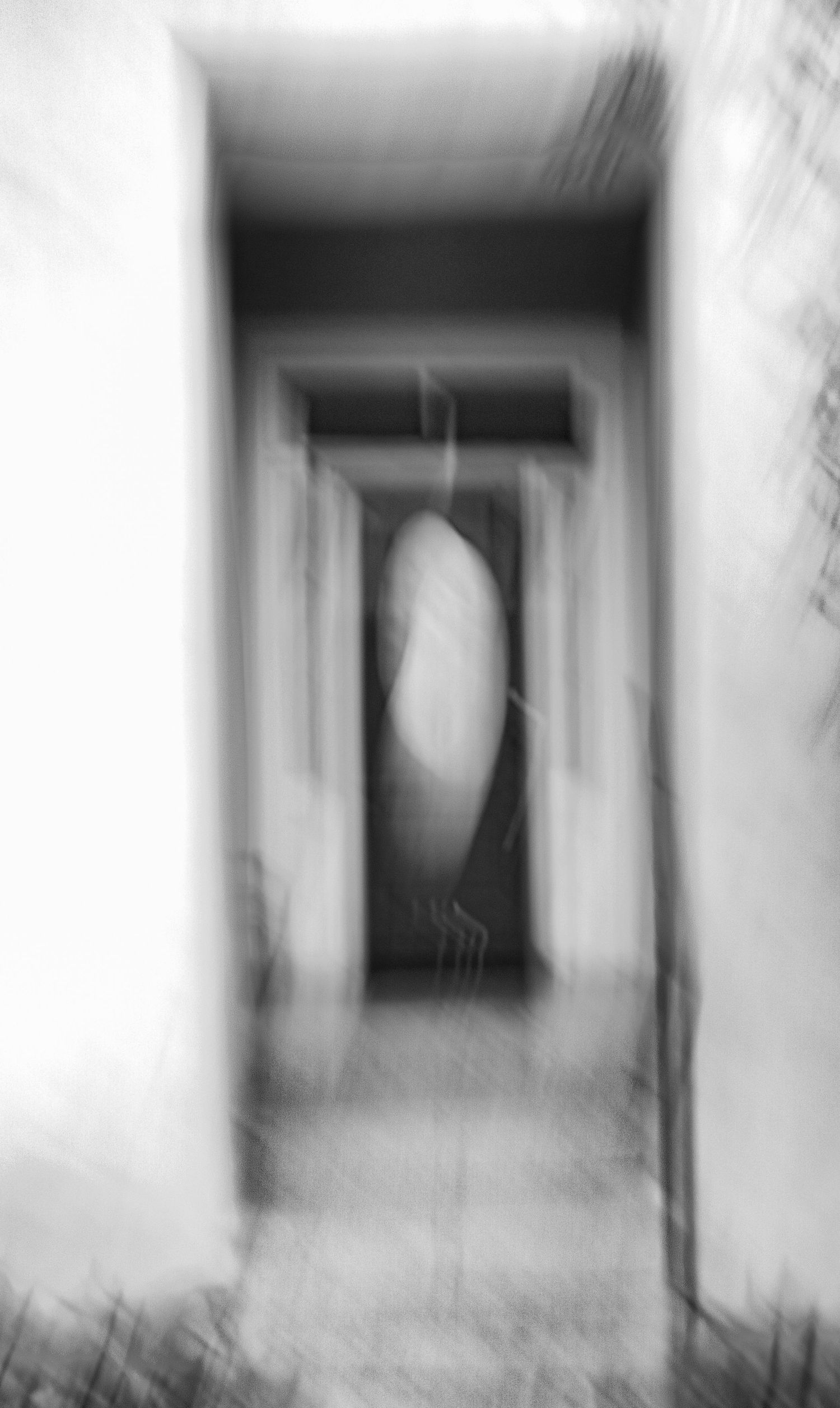 Abstract black and white hallway with soft focus and ethereal lighting effects.