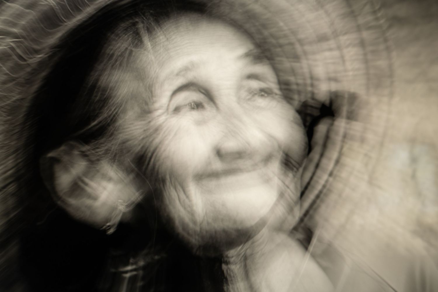 Artistic black and white portrait with motion blur creating an ethereal effect.