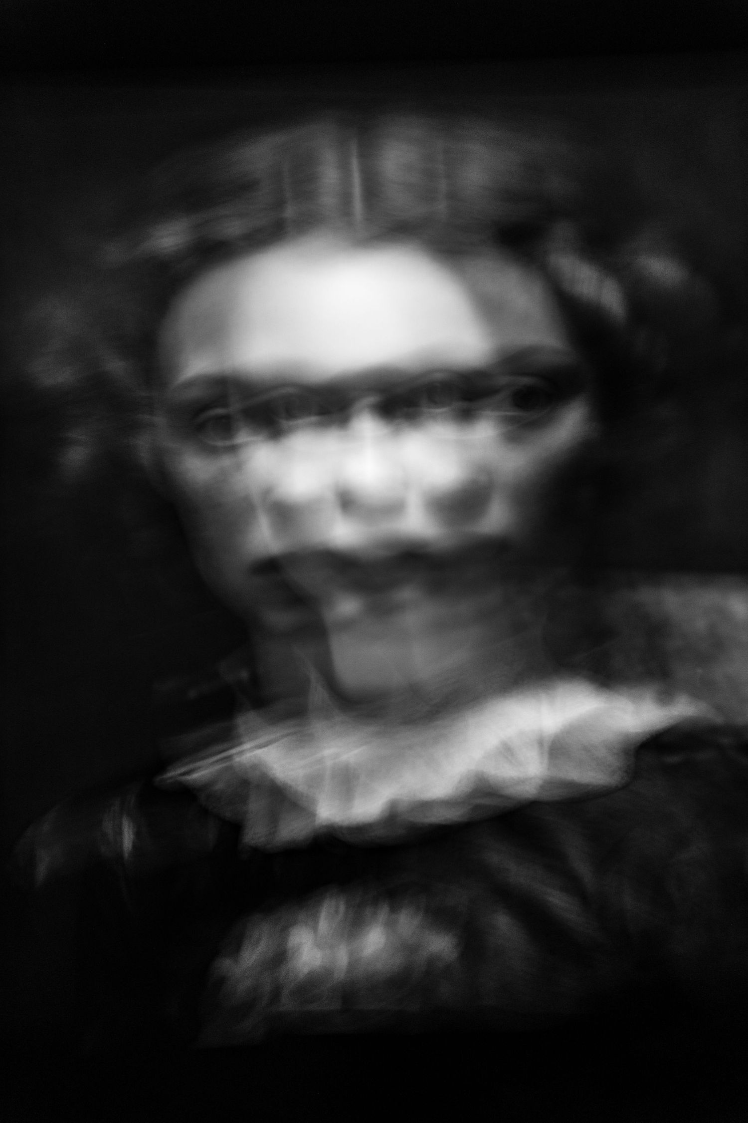 Abstract blurred portrait with ghostly double exposure effect in monochrome.