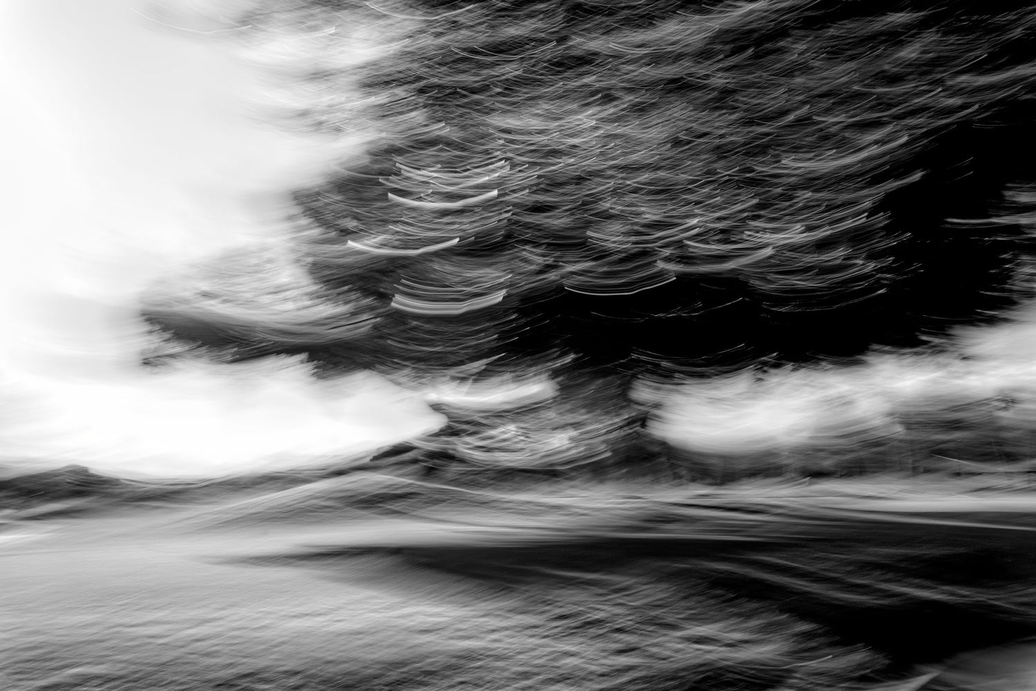 Moody monochromatic seascape with turbulent waves and dark stormy clouds.