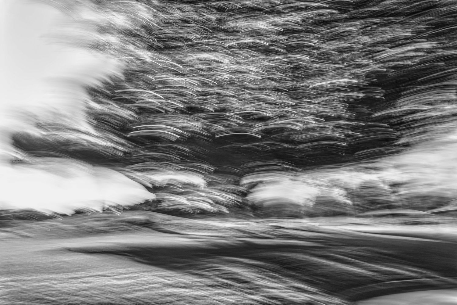 Dynamic black and white ocean waves creating abstract patterns in motion.
